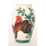 A Moorcroft Pottery vase decorated in the Plum Tree and Bird pattern designed by Sally Tuffin,