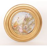 A late 19th Century continental framed plate hand painted with a scene of two ladies and two