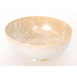 Ruskin Pottery - A shallow footed eggshell bowl decorated in an orange and cream mottled lustre