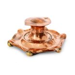 Jesson & Birkett - A copper ink well of hexagonal form with rivet details and raised on six brass