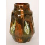 Christopher Dresser - Linthorpe Pottery - A shape 214 vase of barrel form with indented sides,