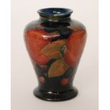 William Moorcroft - A miniature vase of footed baluster form decorated in the Pomegranate pattern,