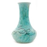 Ruskin Pottery - A vase of compressed globe and shaft form decorated in a mottled tonal green blue