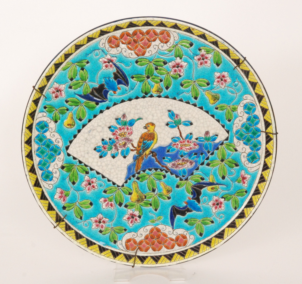 Longwy - A late 19th Century faience wall charger decorated with a fan shaped cartouche with a bird