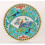 Longwy - A late 19th Century faience wall charger decorated with a fan shaped cartouche with a bird
