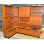 G-Plan - A post war teak corner unit in four sections, with an arrangement of shelves and cupboards.