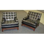 Unknown - A pair of black leather armchairs with loose seat cushions over mahogany stretcher frames