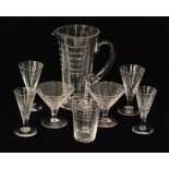 Webb Corbett - A part suite of clear crystal glass comprising a footed pitcher with an applied