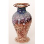 Cobridge Pottery - A contemporary footed baluster vase with flared neck decorated with an all over