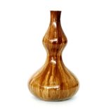 Christopher Dresser - Linthorpe Pottery - A small double gourd vase glazed in a streak pale brown