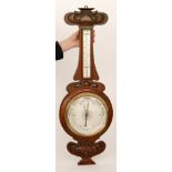 Shapland and Petter - An Art Nouveau oak cased aneroid wheel barometer and thermometer,