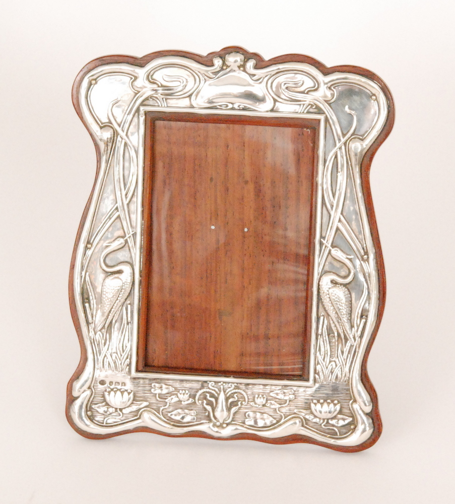 William Atkin - A hallmarked silver rectangular easel photograph frame decorated with twin standing