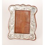 William Atkin - A hallmarked silver rectangular easel photograph frame decorated with twin standing