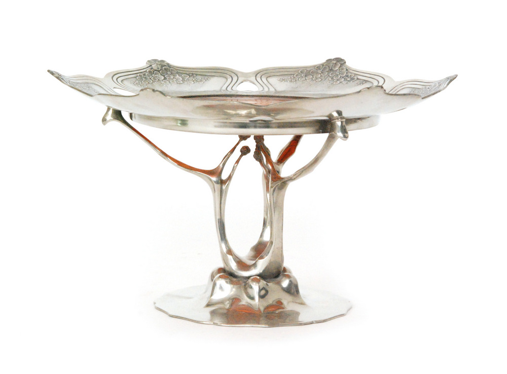 Orivit - A pewter and glass pedestal taza circa 1900 with a shallow dish form top with relief