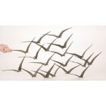 Unknown - A contemporary wall mounted sculpture formed as a flock of birds in flight, width 105cm,