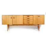 G-Plan - A teak sideboard, model number 4058, fitted with an arrangement of four central drawers,