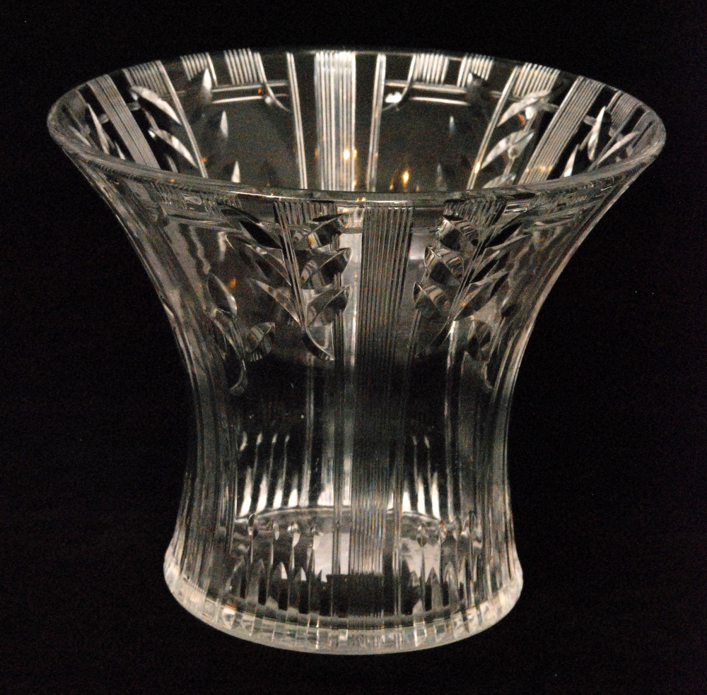 Stuart & Sons - A 1930s clear crystal glass vase of flared form cut with repeat stylised leaves to