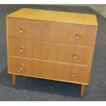 In the manner of Meredew Furniture - A light oak veneered chest of three drawers with circular