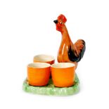Clarice Cliff - Chicken - An egg cup stand circa 1934 modelled as a chicken on a green base