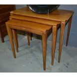 Unknown - A nest of three rectangular teak coffee tables, with canted corners above tapered legs,