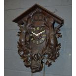 A late 19th to early 20th Century Black Forest cuckoo clock, with cone weights,