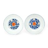 A pair of Chinese Qing Dynasty 18th Century porcelain dishes of shallow circular form hand painted