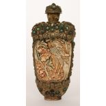 A late 19th Century Chinese white metal and stained ivory snuff bottle the central ivory panels