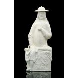 A Ching Dynasty 19th Century Chinese blanc de chine Dutchman typically posed on a high plinth