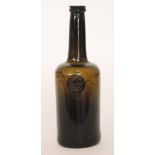 An 18th Century olive green glass wine bottle of mallet form with a kick up pontil with an applied