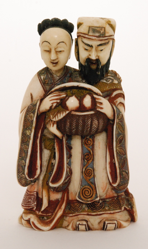A late 19th Century Chinese part stained ivory double snuff bottle carved as a male and female