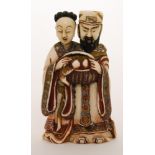 A late 19th Century Chinese part stained ivory double snuff bottle carved as a male and female
