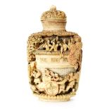 A 19th Century Chinese ivory snuff bottle carved in deep relief with figures and pavilions between