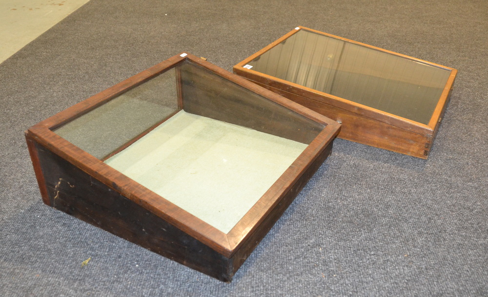 Two early 20th Century table top display cabinets each with sloping fronts,