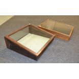 Two early 20th Century table top display cabinets each with sloping fronts,