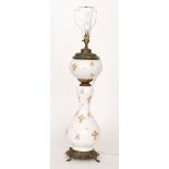 A late Victorian baluster white opaque and gilt overpainted oil lamp,