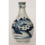 A late 19th to early 20th Century bottle vase with a knop ring to the neck decorated in blue and