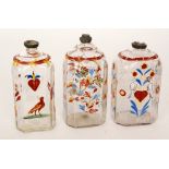 A group of three 18th Century German spirit flasks of canted sleeve from enamelled with verses,