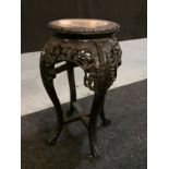 A late 19th to early 20th Century Oriental export carved hardwood jardiniere stand,