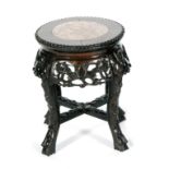 An Oriental export hardwood jardiniere stand with rouge marble inset top above the foliate relief