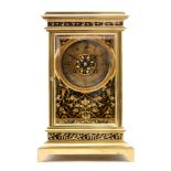 An early 20th Century brass mantle clock with eight day movement enclosed by a bevelled glazed case