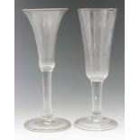 An 18th Century ale glass circa 1740, tall funnel bowl above a plain stem and folded conical foot,