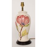 A Moorcroft Pottery table lamp of baluster form decorated in the Magnolia pattern,