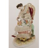 A late 19th Century Volkstedt Dresden lace figure of a lady sat asleep in an armchair with a floral