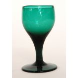 An 18th Century deep green drinking glass circa 1750, ovoid bowl above a plain stem,