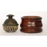 A bronze Tibetan claw prayer bell within an associated turned wooden stand, diameter 17cm.