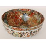 A large early 20th Century Japanese export footed bowl decorated with cartouche panels of dragons