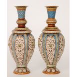 A pair of early 20th Century Metlach shape 1256 vases each decorated in tones of blue and brown,
