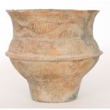 An African terracotta flared lip vessel with a band of incised naive decoration to a cone foot,