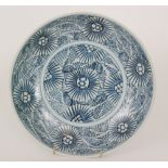 A Chinese Diana Cargo blue and white 'Starburst' shallow dish decorated with a stylised repeat