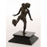 An early 20th Century Burmese bronze figure of a juggler balancing a ball on his shoulder and foot
